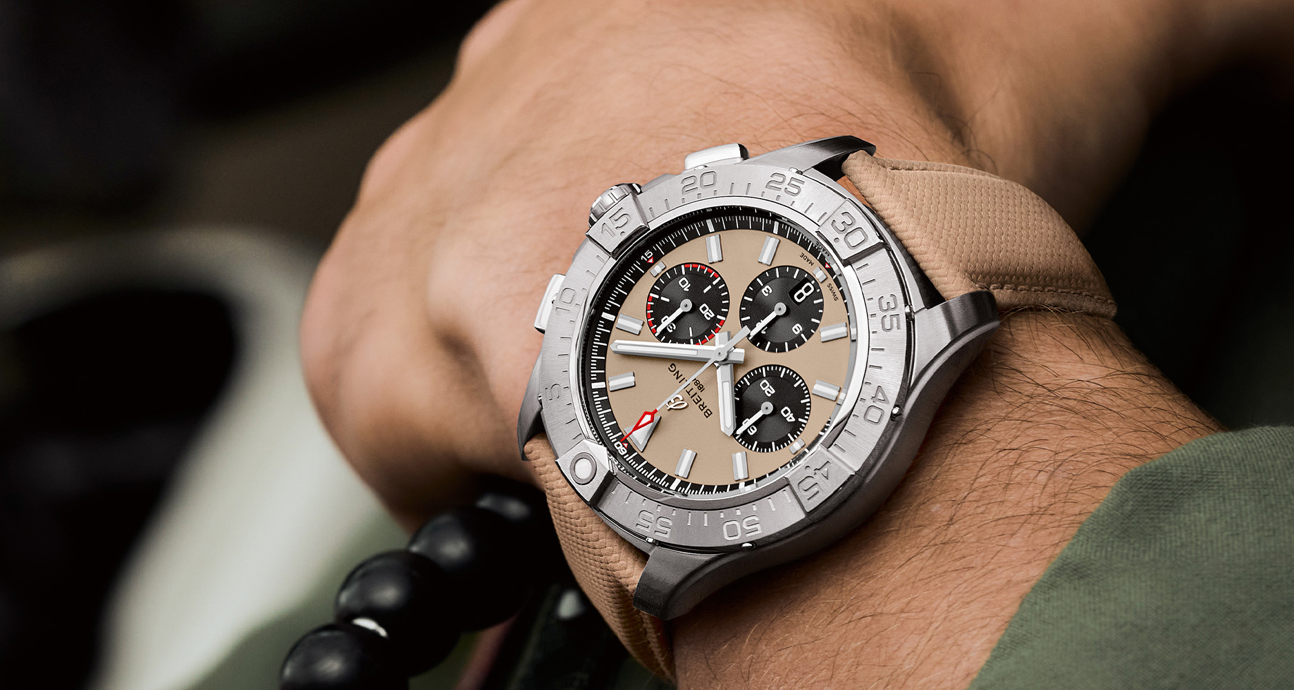 The Breitling Avenger B01 Chronograph 44 with sand dial on the wrist of a Patrouille Suisse pilot.