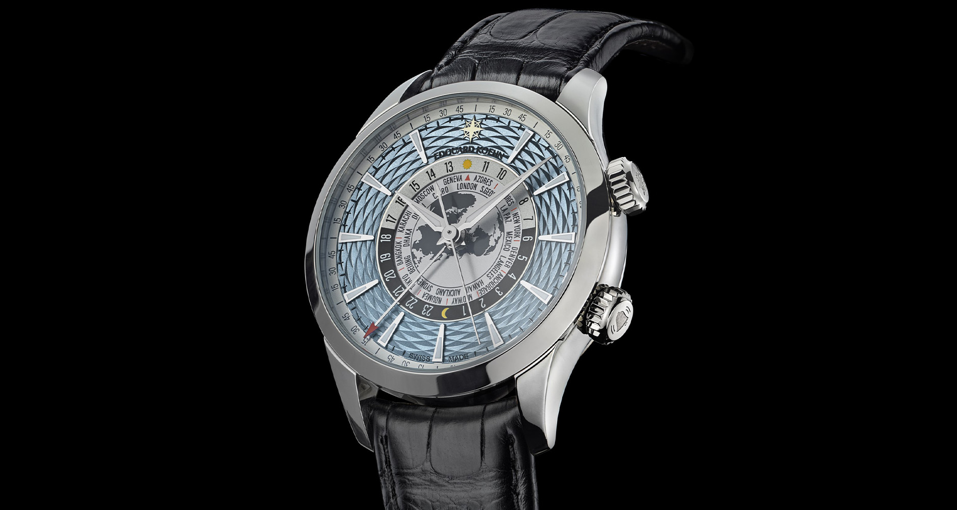 The three hand indicators on the dial are Alpha hands for the hours and minutes of local and world time, while the red arrow hand indicates the alarm.