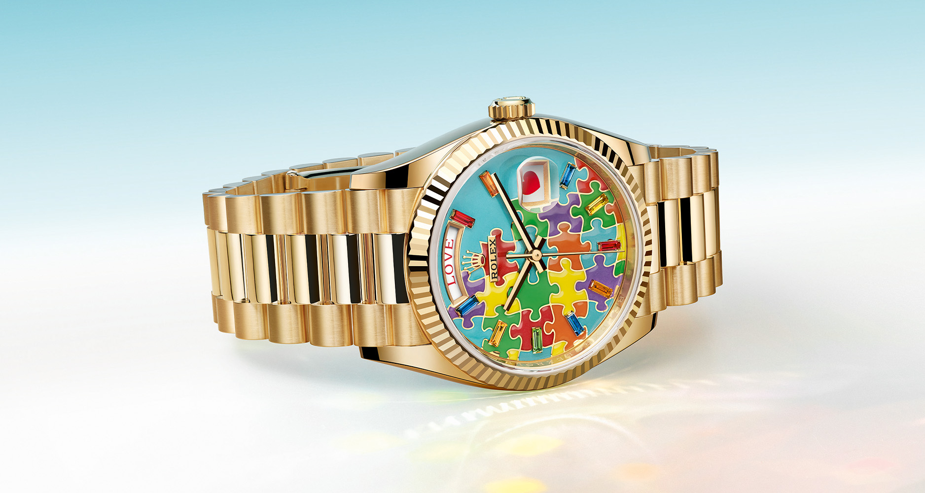 The Rolex Oyster Perpetual Day-Date 36mm in yellow gold case and champlevé enamel dial.